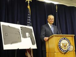 U.S. Sen Charles Schumer, (D-New York), stands beside two photographs of what appears to be a cell phone, but is actually a handgun, during a press conference in his office, Monday, April 4, 2016, in New York. According to the website of Ideal Conceal, the company that is developing the product, their handgun is a double-barreled .380 caliber gun that can serve as a concealed weapon. (AP Photo/Kathy Willens)