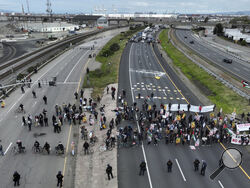 Protesters calling for a cease fire in Gaza shut down southbound traffic on Highway 880 in Oakland, Calif. on Monday, April 15, 2024. (Bronte Wittpenn/San Francisco Chronicle via AP)