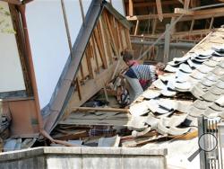 Residents look for their belongings amid debris of a house destroyed by Thursday's earthquake in Mashiki, Kumamoto prefecture, southern Japan, Friday, April 15, 2016. The powerful earthquake struck Thursday night, knocking down houses and buckling roads. (Naoya Osato/Kyodo News via AP)