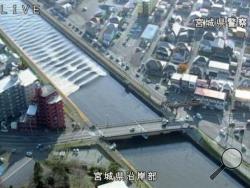 In this image made from video released by Miyagi Prefectural Police, the water flows up river in the Sunaoshi River in Tagajo, Miyagi prefecture, northern Japan, as a tsunami warning is issued following a strong earthquake Tuesday, Nov. 22, 2016. A powerful earthquake off the northeast Japanese shore Tuesday sent residents fleeing to higher ground and prompted worries about the Fukushima nuclear power plant destroyed by a tsunami five year ago. The warning was lifted nearly four hours later. (Miyagi Prefect