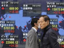 In this Monday, Feb. 15, 2016, File photo, people walk by an electronic stock board of a securities firm in Tokyo, depicting a world map. The realization is dawning that growth may continue to underperform, and that recent turmoil may be more than just normal market volatility, while in Japan the yield on 10-year bonds briefly turned negative, unfamiliar territory even for this financial crisis. (AP Photo/Koji Sasahara)