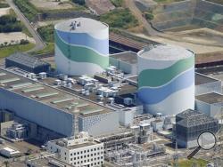 This aerial photo shows reactors of No. 1, right, and No. 2, left, at the Sendai Nuclear Power Station in Satsumasendai, Kagoshima prefecture, southern Japan, Tuesday, Aug. 11, 2015. Kyushu Electric Power Co. said Tuesday, Aug. 11, 2015, it had restarted the No. 1 reactor at its Sendai nuclear plant as planned. (Kyodo News via AP)