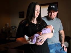 Amanda and Mark Anders of Missoula, Mont., admire their new baby girl, Nicollette Brynn Anders, at their home on Thursday, Nov. 14, 2013. Nicollette Brynn Anders was born in the 11th month, on the 12th day in the 13th year at 14:15 military time. (AP Photo/Michael Gallacher, The Missoulian)