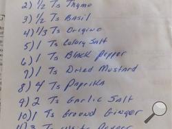 In this August 2016, photo, a handwritten list of 11 herbs and spices, jotted down on the back of the will for Claudia Sanders, the late wife of Colonel Harland Sanders who created his world-famous Kentucky Fried Chicken, is displayed in Corbin, Ky. KFC says the recipe published in the Chicago Tribune is not authentic. But that hasn't stopped rampant online speculation that one of the most legendary and closely guarded secrets in the history of fast food has been exposed. (Jay Jones/Chicago Tribune via AP)