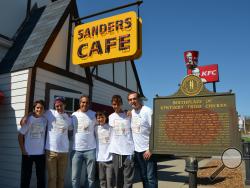 In this Saturday, April 4, 2015 photo, from left, Jason Lutfy, Sebastien Pitre, Neil Janna, Jesse Janna, Josh Janna and Brian Lutfy, from Montreal, pose for a photo outside the Harland Sanders Cafe and Museum in Corbin, Ky. (AP Photo/The Times-Tribune, Jeff Noble)