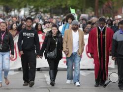 Andrea Irwin, center, mother of Tony Robinson, and her boyfriend, Jeff Jackson, center right, participate in a protest march on Williamson Street, Tuesday, May 12, 2015, in Madison, Wis. (M.P. King/Wisconsin State Journal via AP)
