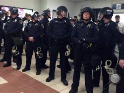 Law enforcement on the ground level tranport area at the Mall of America. A large protest that started at the Mall of America quickly migrated Wednesday, Dec. 23, 2015, to Minneapolis-St. Paul International Airport, where demonstrators blocked roads and caused significant traffic delays. (Leila Navidi/Star Tribune via AP)
