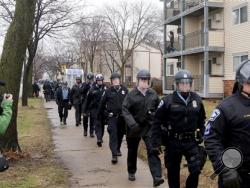 Minneapolis police officers head back toward the Fourth Precinct after being dispatched to head to the 1600 block of Plymouth Ave. N, where protesters had shut down the street Wednesday, March 30, 2016, in Minneapolis, after Hennepin County Attorney Mike Freeman announced that no charges will be filed against two Minneapolis police officers in the fatal shooting of a black man. (David Joles/Star Tribune via AP)