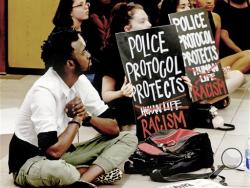 Protesters fill the food court chanting "Black Lives Matter" in the Oklahoma Memorial Union at the University of Oklahoma on Thursday, Sept. 22, 2016 in Norman, Okla. Prosecutors in Tulsa, Oklahoma, charged a white police officer who fatally shot an unarmed black man on a city street with first-degree manslaughter Thursday. (Steve Sisney/The Oklahoman via AP)