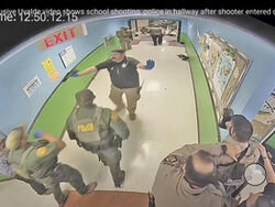 FILE - In this photo from surveillance video provided by the Uvalde Consolidated Independent School District via the Austin American-Statesman, authorities respond to the shooting at Robb Elementary School in Uvalde, Texas, on May 24, 2022. A Justice Department report released Thursday, Jan. 18, 2024 details a myriad of failures by police who responded to the Uvalde, Texas school shooting that led to children waiting desperately for over an hour before officers stormed a classroom to take down the gunman. (