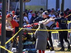 A woman is taken to an ambulance after an incident following the Kansas City Chiefs NFL football Super Bowl celebration in Kansas City, Mo., Wednesday, Feb. 14, 2024. The Chiefs defeated the San Francisco 49ers Sunday in the Super Bowl 58. (AP Photo/Reed Hoffmann)