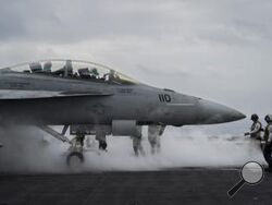 F/A-18F Super Hornet fighter jet takes off from the aircraft carrier U.S.S. Dwight D. Eisenhower, also known as the 'IKE', in the south Red Sea, Tuesday, Feb. 13, 2024. (AP Photo/Bernat Armangue)