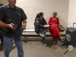 A FBI agent talks to a passenger at Terminal 7 in Los Angeles International Airport, Sunday, Aug. 28, 2016. Reports of a gunman opening fire that turned out to be false caused panicked evacuations at Los Angeles International Airport on Sunday night, while flights to and from the airport saw major delays. A search through terminals brought no evidence of a gunman or shots fired, Los Angeles police spokesman Andy Neiman said. (AP Photo/Ringo H.W. Chiu)