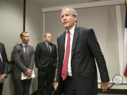 Republican Texas Attorney General Ken Paxton walks away after announcing Texas' lawsuit to challenge President Obama's transgender bathroom order during a news conference in Austin, Texas, Wednesday May 25, 2016. Texas and several other states are suing the Obama administration over its directive to U.S. public schools to let transgender students use the bathrooms and locker rooms that match their gender identity. (Jay Janner/Austin American-Statesman via AP)