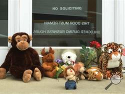 Stuffed animals adorn the doorstep of Dr. Walter Palmer's River Bluff Dental office in Bloomington, Minn., Tuesday, July 28, 2015. Palmer, accused of illegally killing a protected lion in Zimbabwe, said Tuesday that he thought everything about his trip was legal and wasn't aware of the animal's status "until the end of the hunt." (Scott Takushi/Pioneer Press via AP)