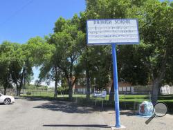 In this Thursday, May 26, 2016 photo, an empty school reader board stands in front of the only school building in Dietrich, Idaho. The small community is struggling with the national attention brought by reports that a disabled black football player was raped by his white high school teammates. The allegations of racist taunts and physical abuse suffered by the teen were revealed this month when the family filed a $10 million lawsuit against the Dietrich School District. (AP Photo/Kimberlee Kruesi)