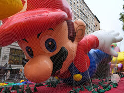 People pass Mario balloon during inflation for the 99th Macy's Thanksgiving Day Parade Wednesday, Nov. 26, 2025, in New York. (AP Photo/Frank Franklin II)