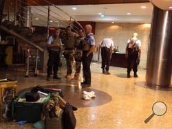 French troops, rear, inside the Radisson Blu hotel after an attack by gunmen on the hotel in Bamako, Mali, Friday, Nov. 20, 2015. Islamic extremists armed with guns and grenades stormed the luxury Radisson Blu hotel in Mali's capital Friday morning, and security forces worked to free guests floor by floor. (AP Photo/Baba Ahmed)