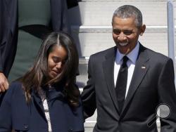 In this March 7, 2015 file photo, President Barack Obama and Malia Obama arrive at Air Force One at Maxwell Air Force Base in Montgomery, Ala. (AP Photo/Butch Dill, File)