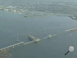 Parts of the Francis Scott Key Bridge remain after a container ship collided with a support Tuesday, March 26, 2024 in Baltimore. The major bridge in Baltimore snapped and collapsed after a container ship rammed into it early Tuesday, and several vehicles fell into the river below. Rescuers were searching for multiple people in the water. (WJLA via AP)