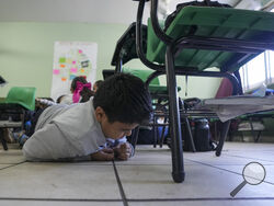 A student participates in an active shooter drill at the Socrates elementary school in Culiacan, Mexico, Thursday, Feb. 27, 2025. (AP Photo/Fernando Llano)