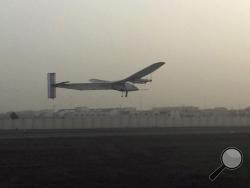 A Swiss solar-powered plane takes off at an airport in Abu Dhabi, United Arab Emirates, early Monday, March 9, 2015, marking the start of the first attempt to fly around the world without a drop of fuel. (AP Photo/Aya Batrawy)