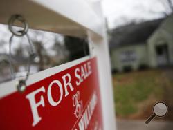 This Jan. 26, 2016 file photo shows a "For Sale" sign hanging in front of an existing home in Atlanta. (AP Photo/John Bazemore, File)