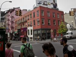 This Aug. 8, 2012, file photo shows a residential storefront building at the corner of Prince Street and Broadway, after an earlier police search of the building in the ongoing Etan Patz investigation in the SoHo section of New York, where Patz disappeared on May 25, 1979. 