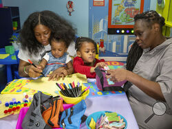 Inmate Nadine Leach, 43, right, visits with her grandchildren and daughter Lashawna Jones, 27, in the newly opened preschool play and learn visitation hub in the Rose M. Singer Center at the Rikers Island jail complex in the Bronx borough of New York, on Tuesday, May 7, 2024. (AP Photo/Ted Shaffrey)