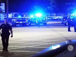 Law enforcement and other emergency personnel respond to the scene of a shooting at the Grand Theatre on Thursday, July 23, 2015, in Lafayette, La. (Leslie Westbrook/The Advocate via AP)