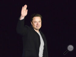 FILE - SpaceX's Elon Musk waves while providing an update on Starship, on Feb. 10, 2022, near Brownsville, Texas. Twitter on Thursday, Dec. 15, 2022, suspended the accounts of journalists who cover the social media platform and Musk, including reporters working for The New York Times, Washington Post, CNN and other publications (Miguel Roberts/The Brownsville Herald via AP, File)