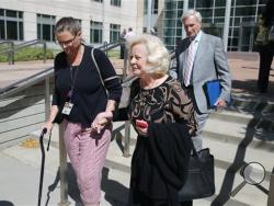 Yvonne and Bob Bertolet, center and right, the parents of Toni Henthorn, walk with a family friend from a federal courthouse in Denver, Friday, Sept. 18, 2015, following closing arguments in the murder trial of Harold Henthorn, who is charged with killing his second wife, Toni Henthorn, on a hike they took to celebrate their wedding anniversary in 2012. (AP Photo/Brennan Linsley)