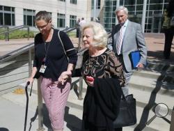Yvonne and Bob Bertolet, center and right, the parents of Toni Henthorn, walk with a family friend from a federal courthouse in Denver, Friday, Sept. 18, 2015, following closing arguments in the murder trial of Harold Henthorn, who is charged with killing his second wife, Toni Henthorn, on a hike they took to celebrate their wedding anniversary in 2012. (AP Photo/Brennan Linsley)
