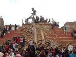 People stand around damage caused by an earthquake at Durbar Square in Kathmandu, Nepal, Saturday, April 25, 2015. A strong magnitude-7.9 earthquake shook Nepal's capital and the densely populated Kathmandu Valley before noon Saturday, causing extensive damage with toppled walls and collapsed buildings, officials said. (AP Photo/ Niranjan Shrestha)