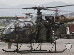 A Nepalese army chopper, that spotted the suspected wreckage of a U.S. Marine helicopter, lands at the airport in Kathmandu, Nepal, Friday, May 15, 2015. (AP Photo/Bernat Armangue)