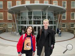 High School juniors Brian Keyes and Isabel Suarez, both 16, pose for a photograph in front of Woodrow Wilson High School in Washington, Thursday, March 3, 2016, after recently taking the new SAT exam. The new exam focuses less on arcane vocabulary words and more on real-world learning and analysis by students. Students no longer will be penalized for guessing. And the essay has been made optional. (AP Photo/Andrew Harnik)