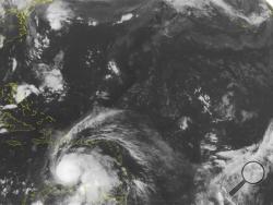 This NOAA satellite image taken Friday, Sept. 30, 2016 at 12:45 AM EDT shows strengthening Hurricane Matthew moving westward at 14 MPH across the Caribbean basin. Max sustained winds on Matthew are up to 100 MPH as of 0600 UTC, with some of the outer bands affecting Puerto Rico and Hispaniola. Forecast tracks have Matthew continuing to push westward and strengthening for another few days before turning northward. (NOAA/Weather Underground via AP)