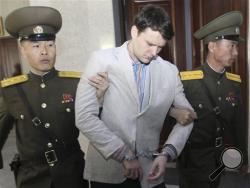 American student Otto Warmbier, center, is escorted at the Supreme Court in Pyongyang, North Korea, Wednesday, March 16, 2016. North Korea's highest court sentenced Warmbier, a 21-year-old University of Virginia undergraduate student, from Wyoming, Ohio, to 15 years in prison with hard labor on Wednesday for subversion. He allegedly attempted to steal a propaganda banner from a restricted area of his hotel at the request of an acquaintance who wanted to hang it in her church. (AP Photo/Jon Chol Jin)