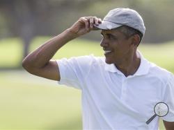 President Barack Obama tips his hat to the crowd after finishing a round of golf at Mid-Pacific Country Club during his family vacation on Monday, Dec. 28, 2015, in Kailua, Hawaii. (AP Photo/Evan Vucci)