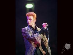 In this Jan. 9, 1997, file photo, David Bowie performs during a concert celebrating his 50th birthday, at Madison Square Garden in New York. Bowie, the innovative and iconic singer whose illustrious career lasted five decades, died Monday, Jan. 11, 2016, after battling cancer for 18 months. He was 69. (AP Photo/Ron Frehm, File)