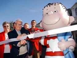 n a Sept. 23, 2003 file photo, the real Linus, artist Linus Maurer, cuts a ribbon after unveiling a statue of Linus of "Peanuts" comic strip fame during a ceremony at his hometown of Sleepy Eye, Minn. (John Cross/The Free Press via AP)