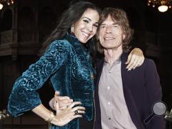 Mick Jagger, right, with designer L’Wren Scott after her Fall 2012 collection was modeled during Fashion Week, in New York. Scott, a fashion designer, was found dead Monday, March 17, 2014, in Manhattan of a possible suicide. (AP Photo/Richard Drew, File)