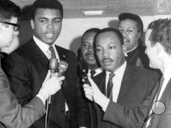 In this March 29, 1967, file photo, heavyweight champion Muhammad Ali, center left, and Dr. Martin Luther King speak to reporters. Ali, the magnificent heavyweight champion whose fast fists and irrepressible personality transcended sports and captivated the world, has died according to a statement released by his family Friday, June 3, 2016. He was 74. (AP Photo/File)