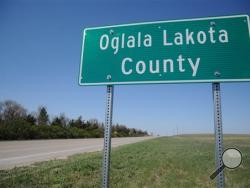This April 29, 2015 photo shows a sign for the newly named Oglala Lakota County in Batesland, S.D. The name change will officially take effect on Friday. (AP Photo/James Nord)