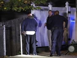 Police search for a suspect after a shooting in the East Boston neighborhood of Boston, Wednesday, Oct. 12, 2016. Police say two officers were shot late Wednesday night. Their conditions were not immediately available. It's unclear what led to the shooting.(AP Photo/Charles Krupa)