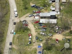 This aerial photo shows two of the locations being investigated in Pike County, Ohio, as part of an ongoing homicide investigation, Friday, April 22, 2016. Several people were found dead Friday at multiple crime scenes in rural Ohio, and at least most of them were shot to death, authorities said. No arrests had been announced, and it's unclear if the killer or killers are among the dead. (Lisa Marie Miller/The Columbus Dispatch via AP) 