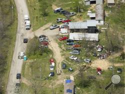 This aerial photo shows two of the locations being investigated in Pike County, Ohio, as part of an ongoing homicide investigation, Friday, April 22, 2016. Several people were found dead Friday at multiple crime scenes in rural Ohio, and at least most of them were shot to death, authorities said. No arrests had been announced, and it's unclear if the killer or killers are among the dead. (Lisa Marie Miller/The Columbus Dispatch via AP) 
