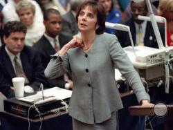 In this Sept. 29, 1995 file photo, prosecutor Marcia Clark makes her closing arguments during the O.J. Simpson double-murder trial in Los Angeles, demonstrating on her own neck where a knife wound was sustained by murder victim Ronald Goldman. (AP Photo/Reed Saxon, Pool, File)