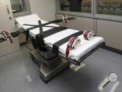 This Oct. 9, 2014, file photo shows the gurney in the the execution chamber at the Oklahoma State Penitentiary in McAlester, Okla. An Oklahoma grand jury investigating the state’s execution procedures said Thursday, May 19, 2016 that a top lawyer for Gov. Mary Fallin encouraged the use of the wrong lethal injection drug in an execution that was later called off. (AP Photo/Sue Ogrocki, File)