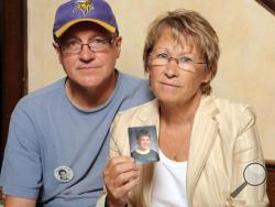 In this Aug. 28, 2009, file photo, Patty and Jerry Wetterling show a photo of their son Jacob Wetterling, who was abducted in October of 1989 in St. Joseph, Minn and is still missing, in Minneapolis. (AP Photo/Craig Lassig, File)